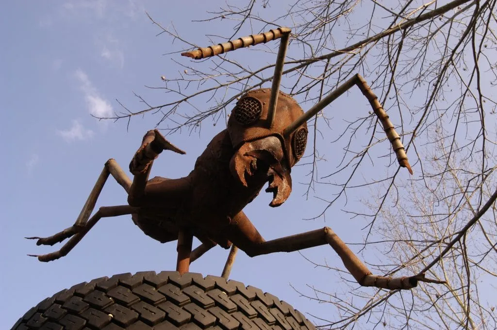 Artisan crafting intricate gold decorative pieces in detailed close-up