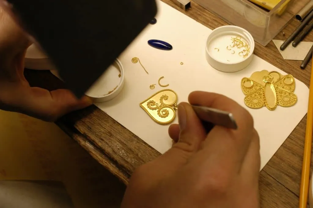Artist working in colorful studio surrounded by abstract paintings